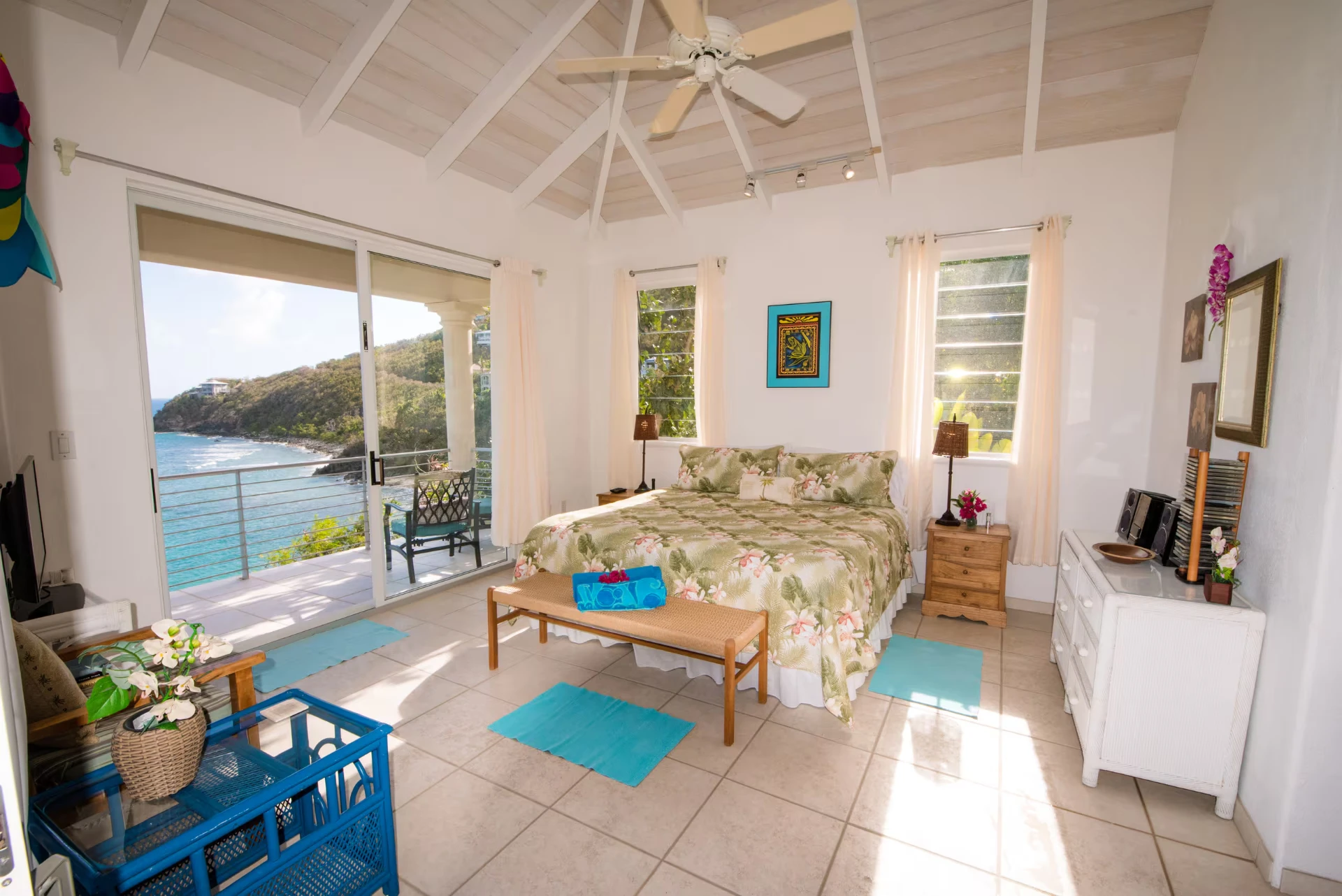 Upper guest suite with king bed and balcony above the bay