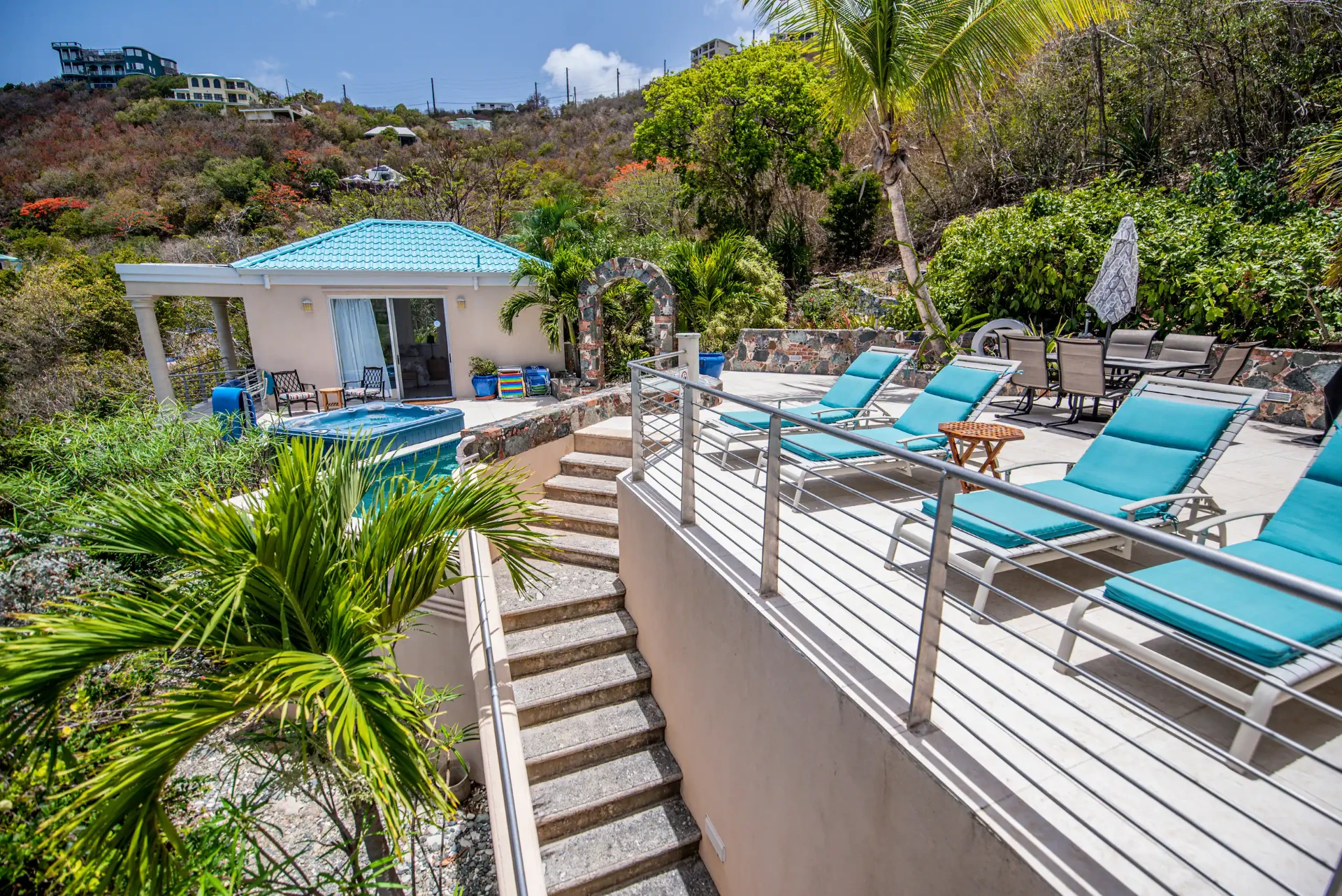 Steps between the sun deck loungers and the pool terrace
