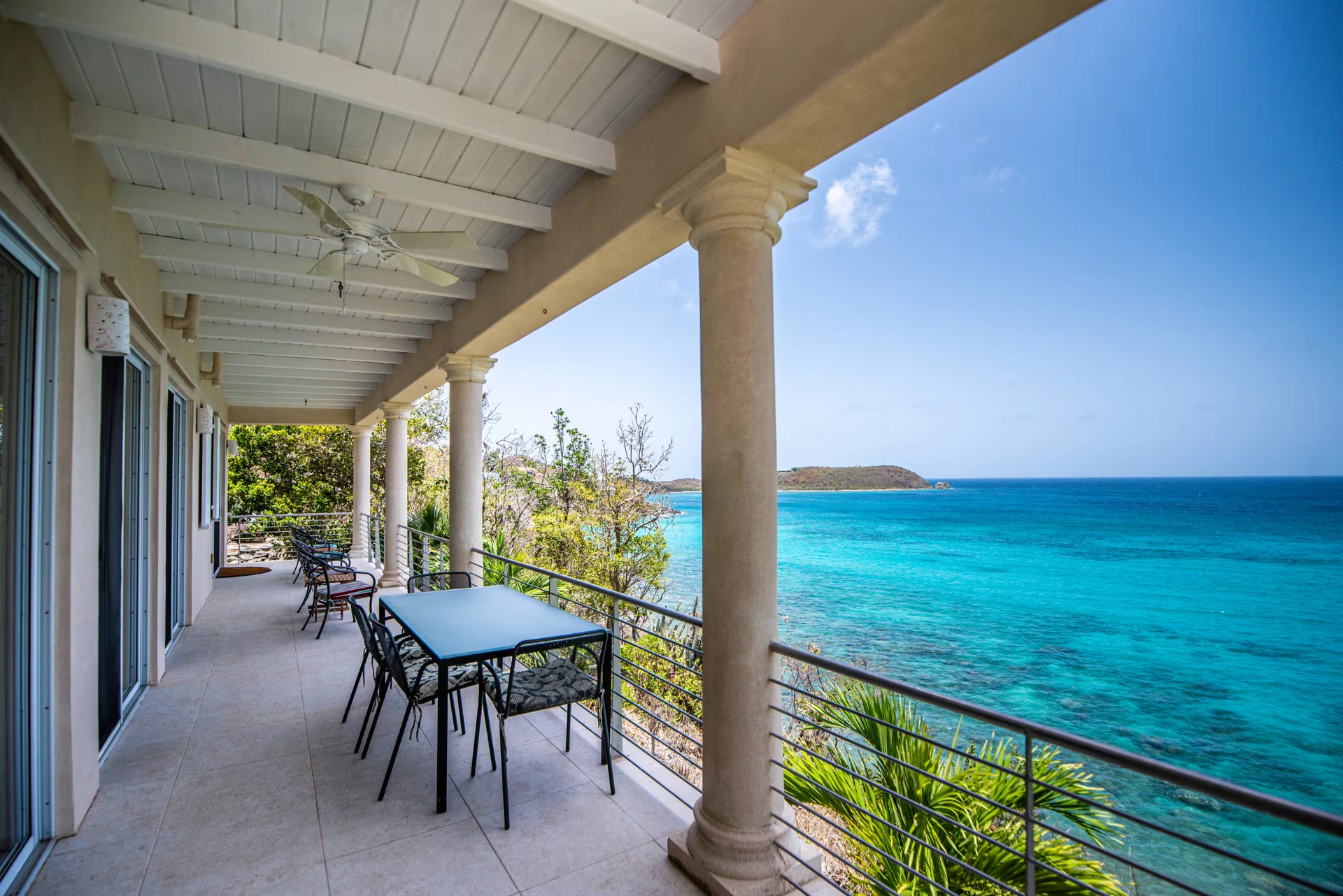 Long covered veranda running the length of the villa above the water