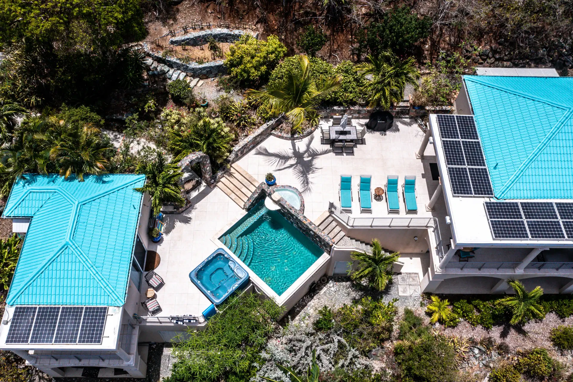 Overhead drone view of the turquoise roofs, pool, hot tub and sun deck